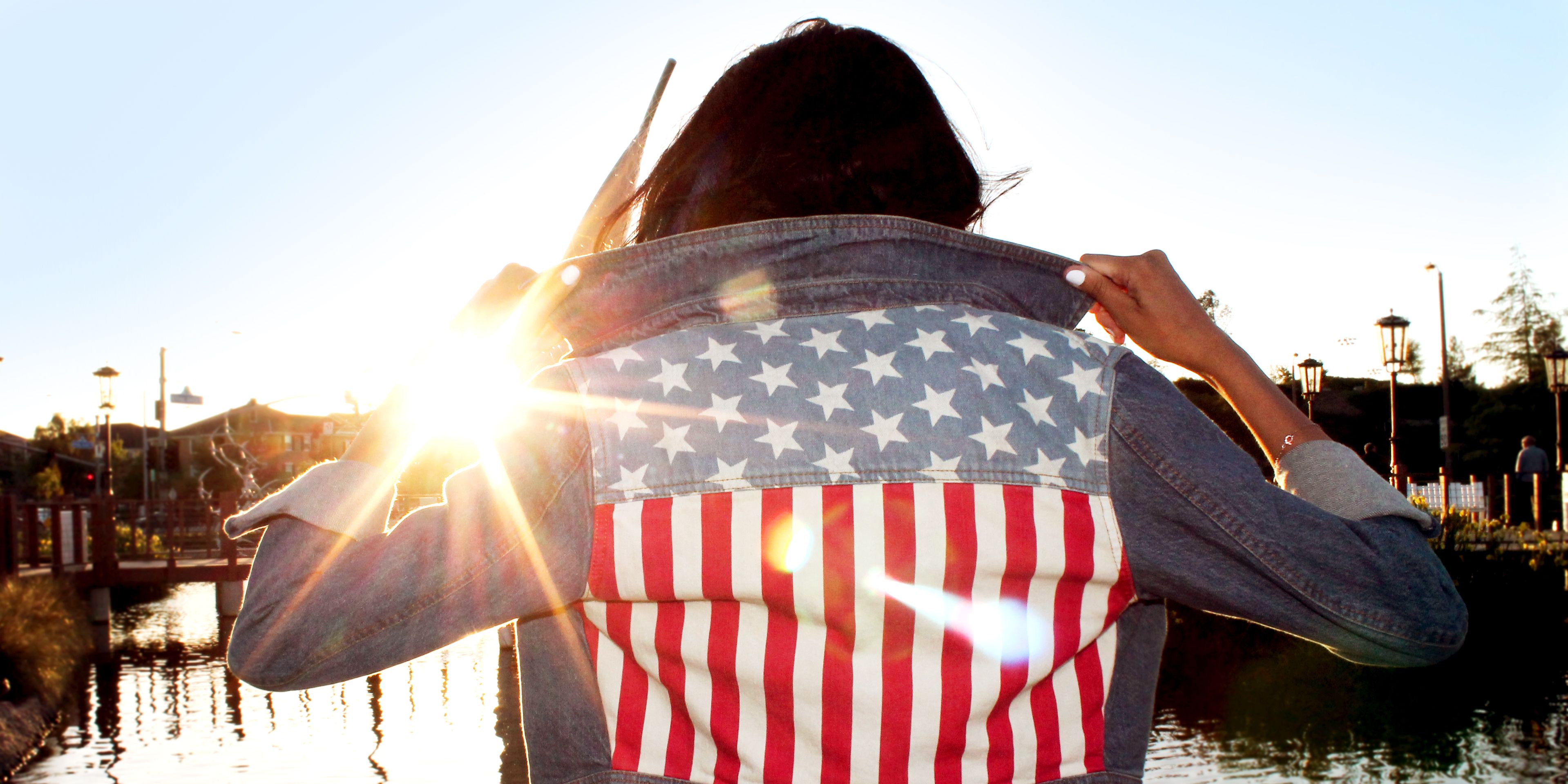 Girl With American Flag Jacket With Sunset