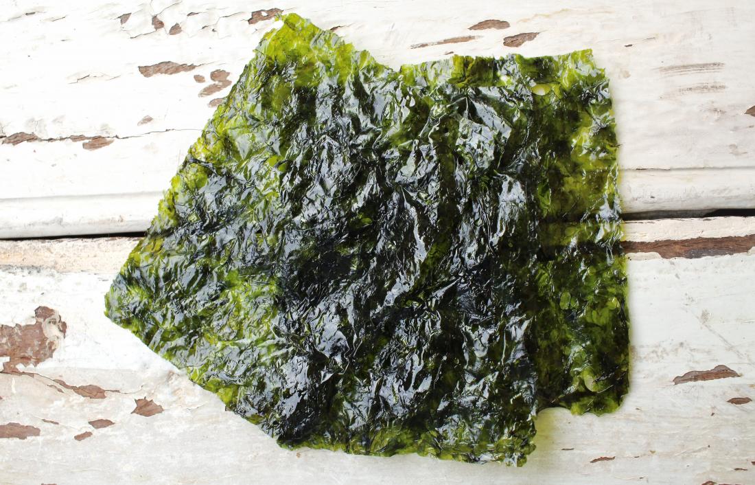 Nori seaweed sheets on wooden surface