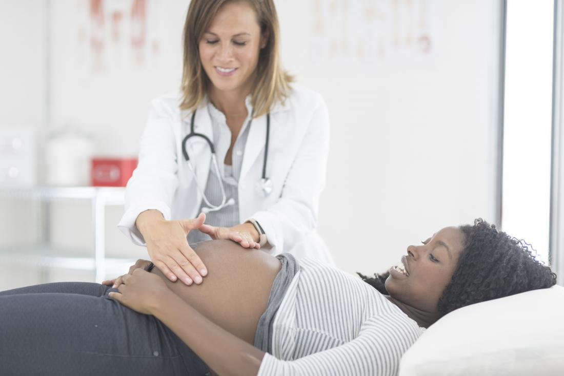 Pregnant woman having a checkup in doctor's office