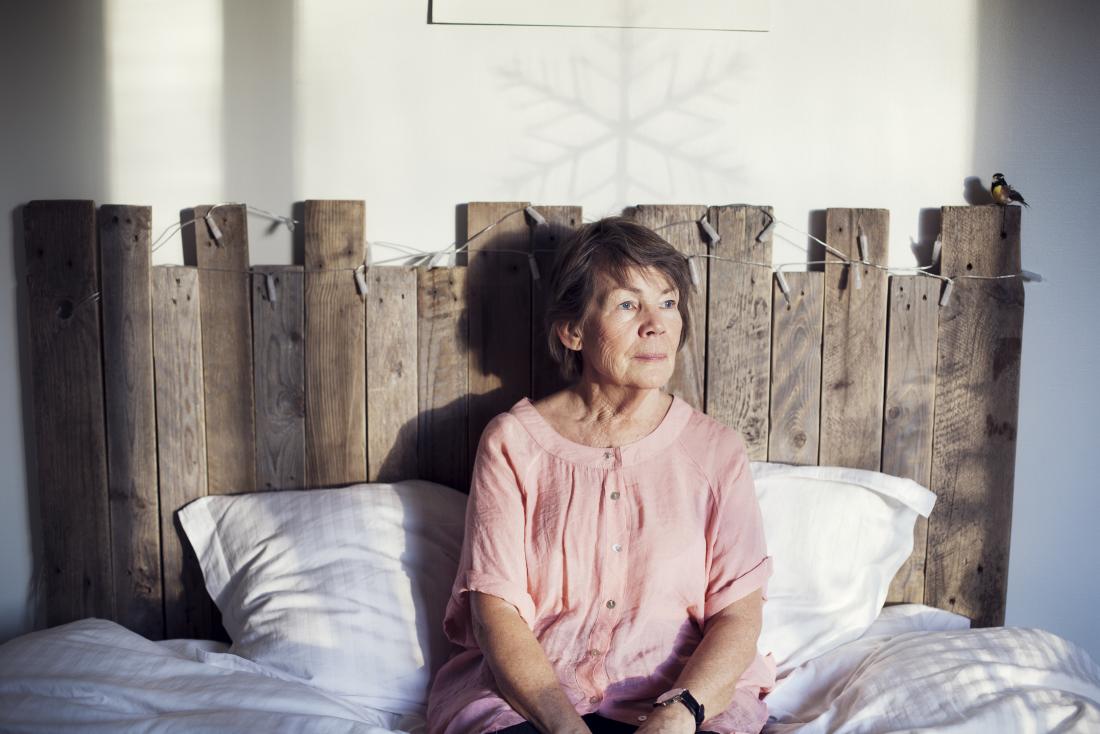 a senior woman sitting in bed