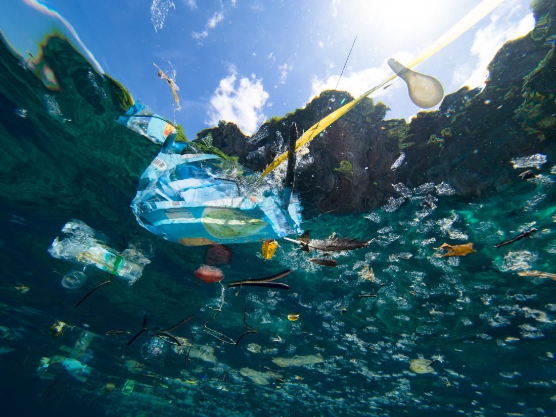 shot of plastic bag and bottles in ocean