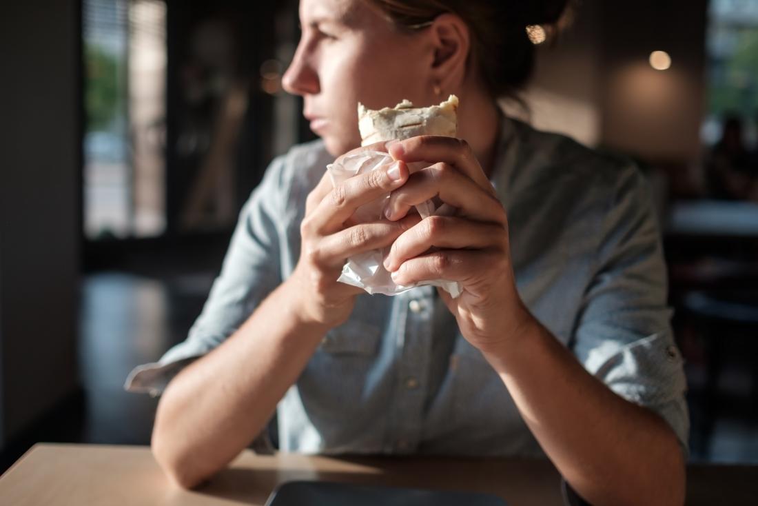 Person eating a burrito for a low-protein diet