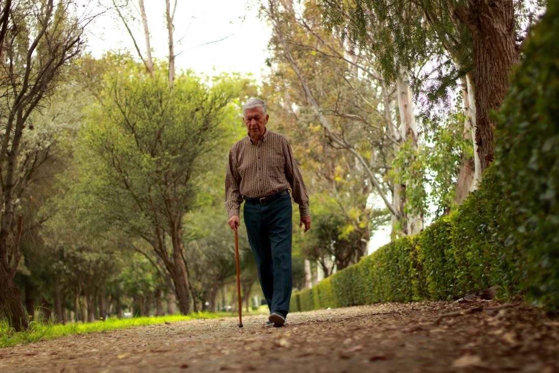 older man walking with cane