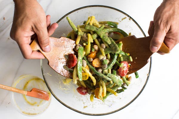 Shell beans, cherry tomatoes, and yellow and green beans serve as the base of a summery salad.