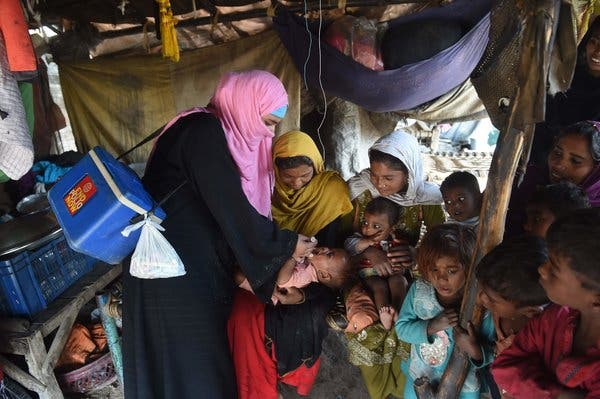 In March, a health worker administered polio vaccine drops to a child during a campaign in Lahore, Pakistan.