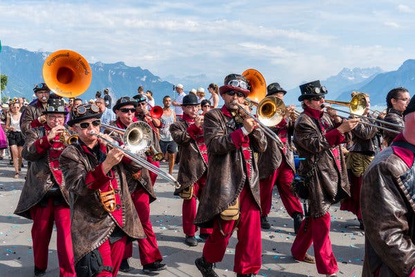A brass band from Fribourg paraded along the shore of Lake Geneva during the Fête des Vignerons.