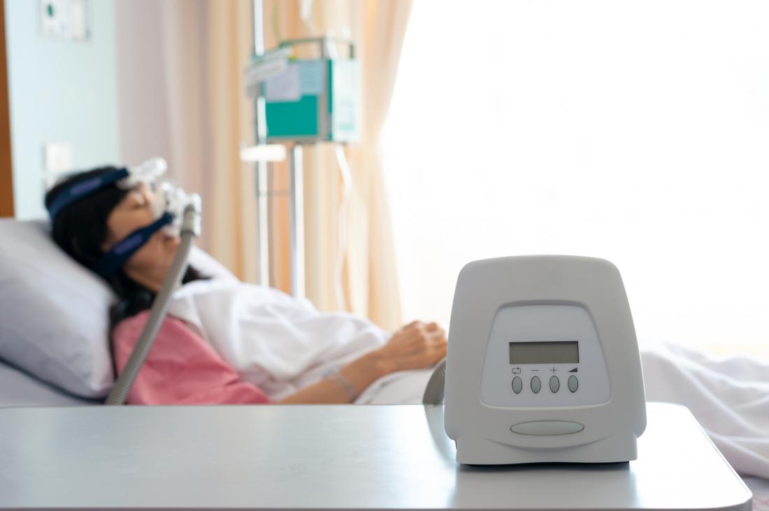 woman sleeping with sleep apnea machine