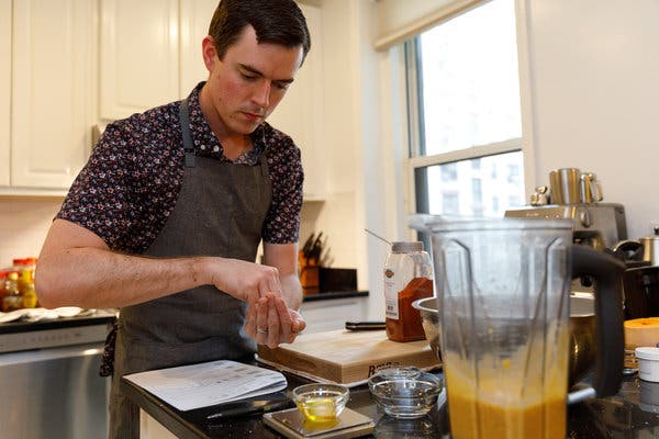 Matt Davis, a co-founder of Mosaic, a frozen food company, tests a recipe for butternut squash risotto in the kitchen of his Brooklyn Heights apartment.