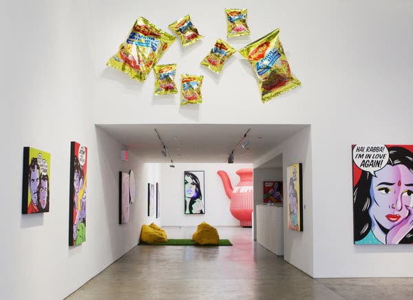 An installation view of Ms. Qamar&rsquo;s exhibition &ldquo;Fraaaandship!,&rdquo; includes Pop art paintings inspired by Indian soap operas, inflated bags of Maggi noodles and nods to cultural life like a 10-foot-tall inflatable red lota.