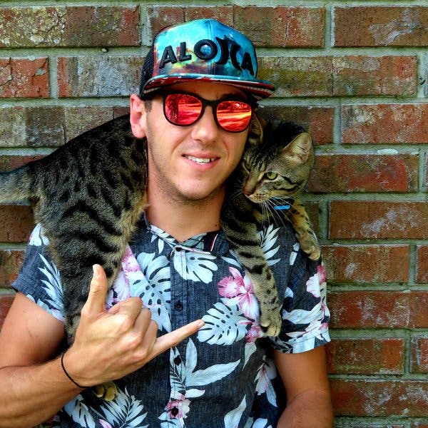 Rich Abernathy, a diver and YouTuber who posts videos as Rich Aloha, with Yogi Bear, his cat.