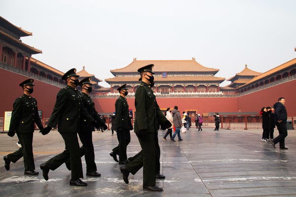 Police officers wearing masks in front of The Palace Museum in Beijing on Sunday.