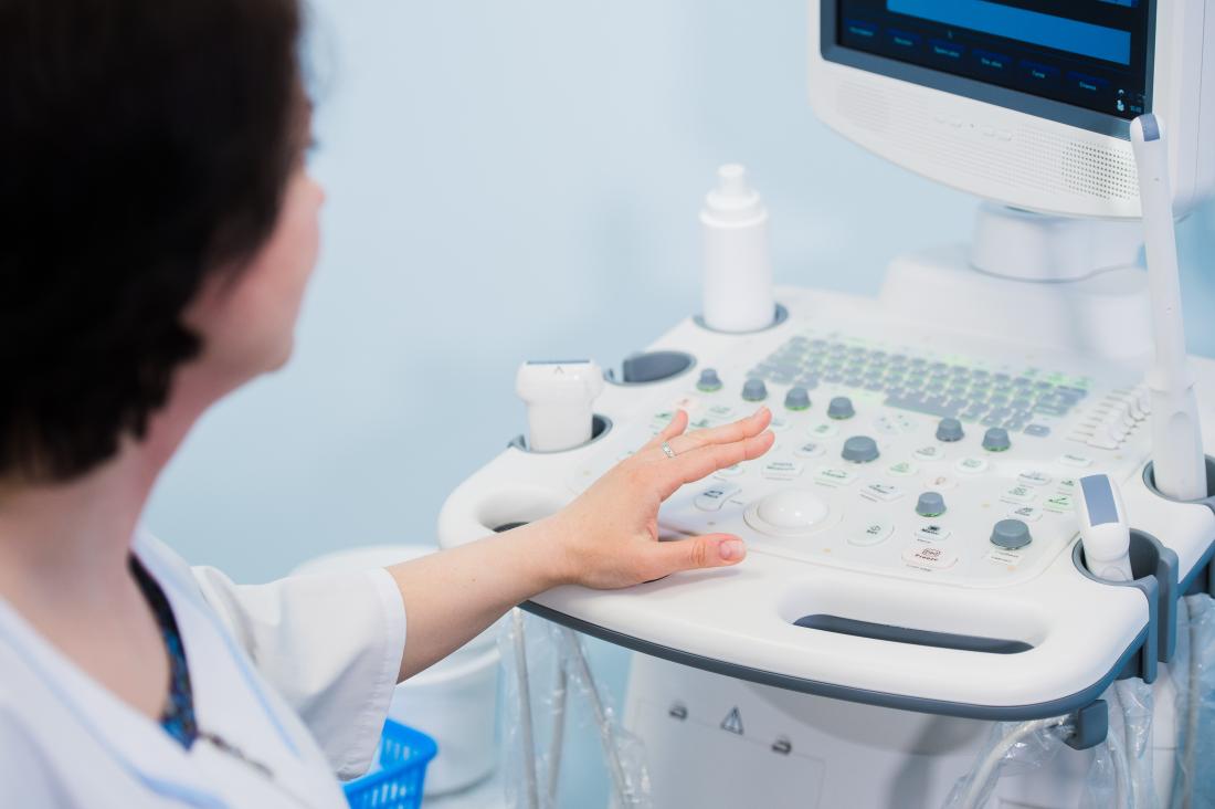 Doctor using ultrasound scanner