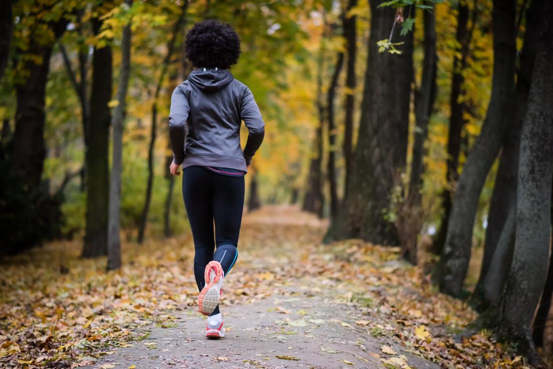 Woman jogging or running in woods