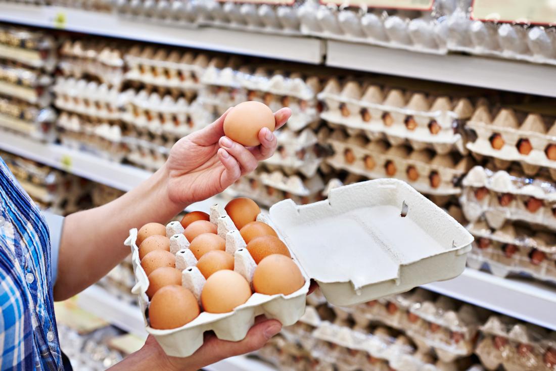 Woman holding eggs in a supermarket