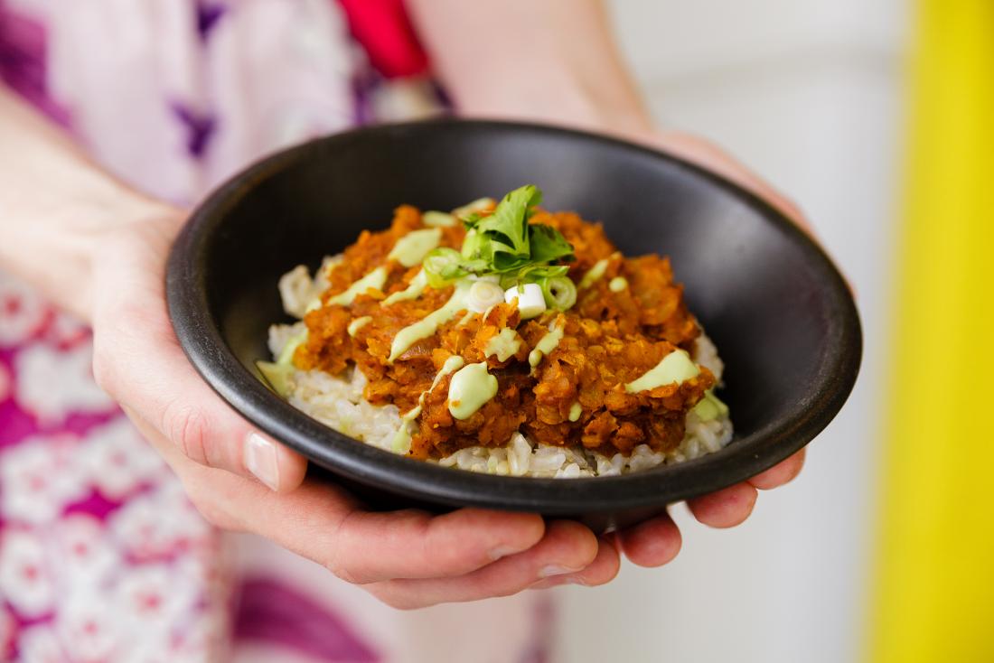 Mexican lentil with rice and avocado aioli in bowl