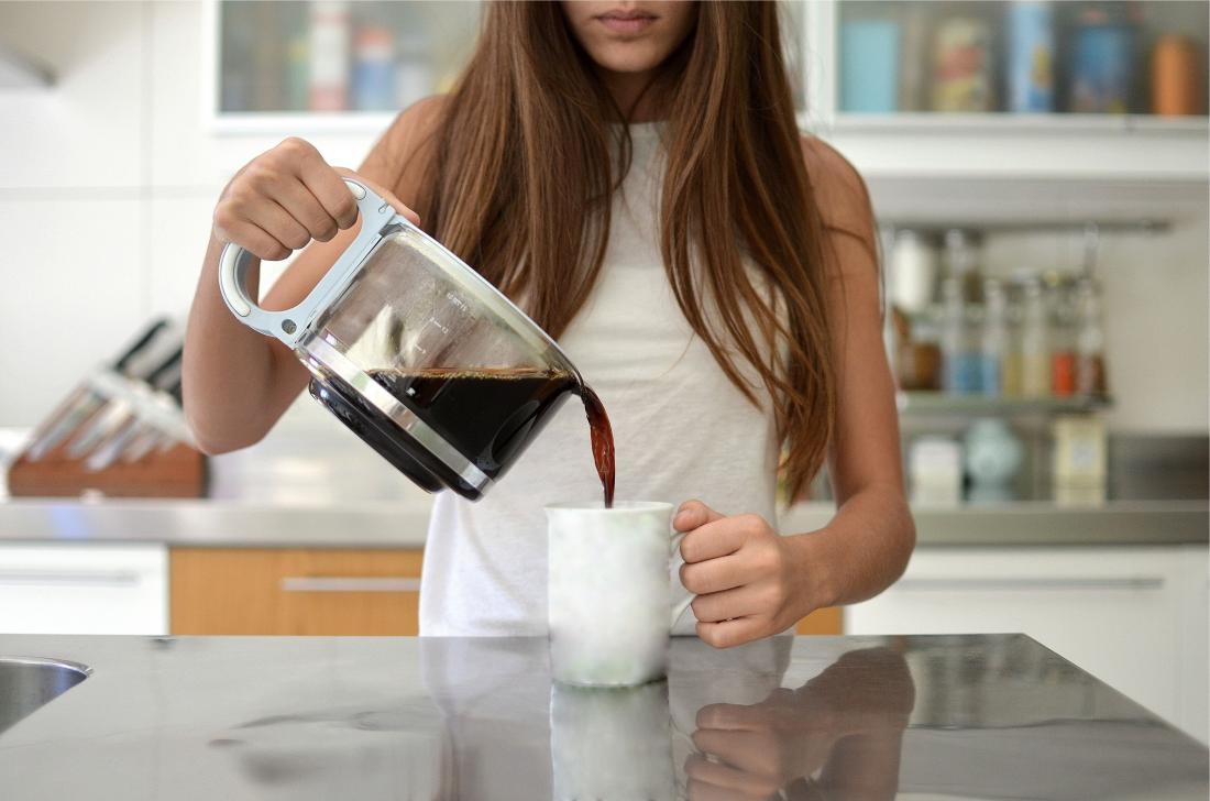 Woman with GERD pouring coffee into tea mug