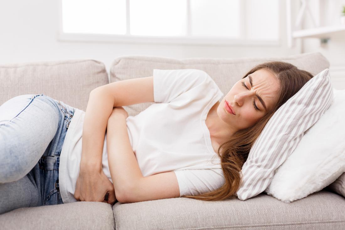 Woman holding her stomach due to a bowel obstruction