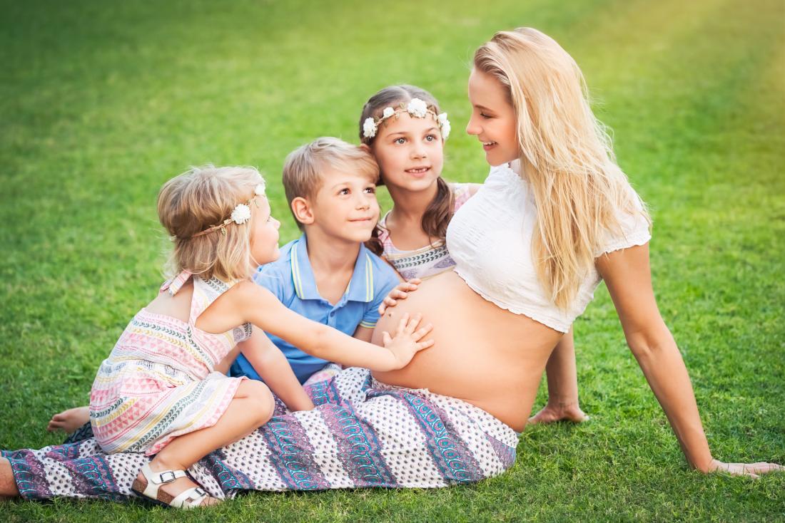 young pregnant woman with her children