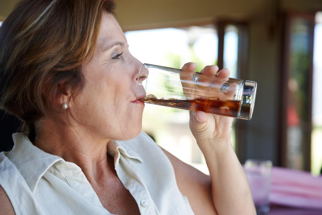senior woman drinking coke