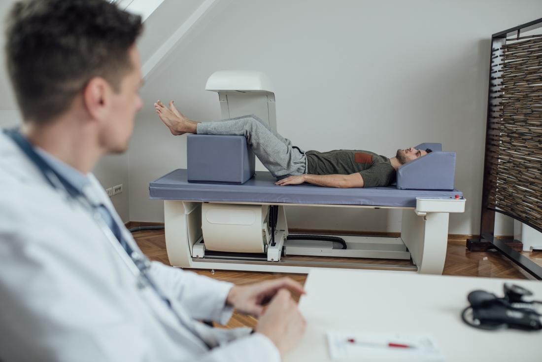 doctor using a dexa scan on a patient
