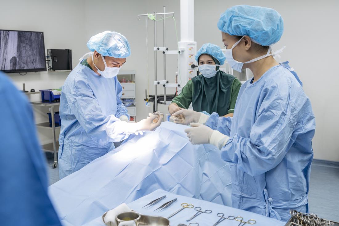 Surgeons working on hemorrhoid surgery