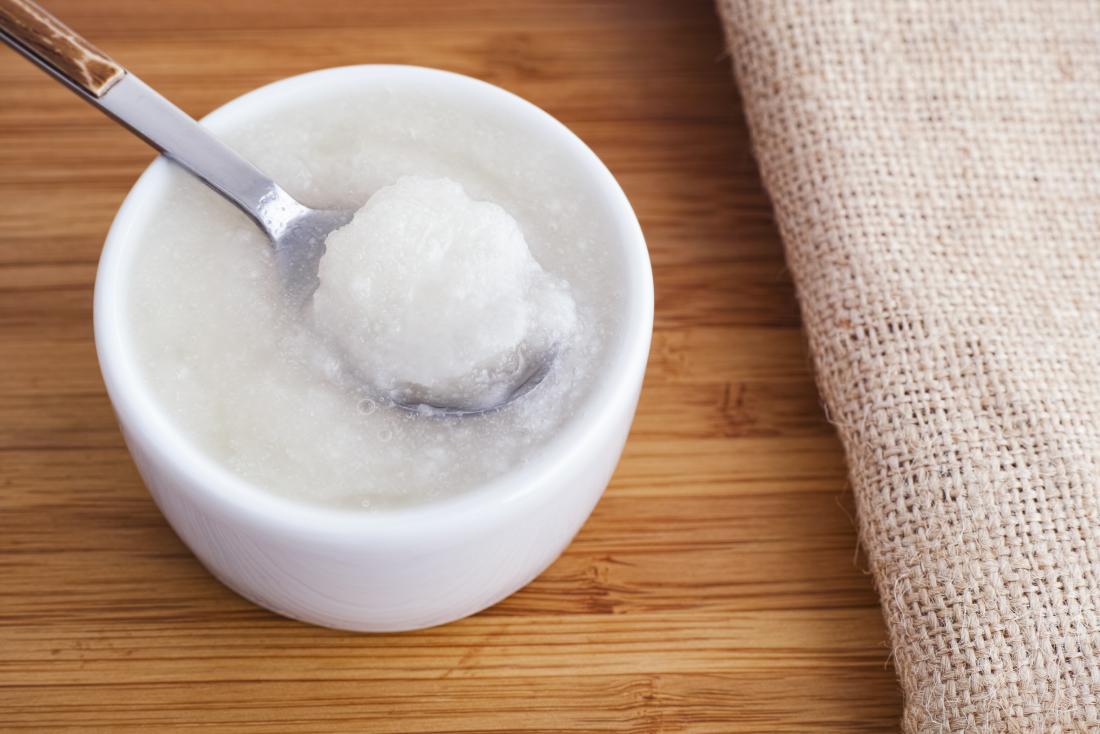 small bowl of coconut oil with spoon