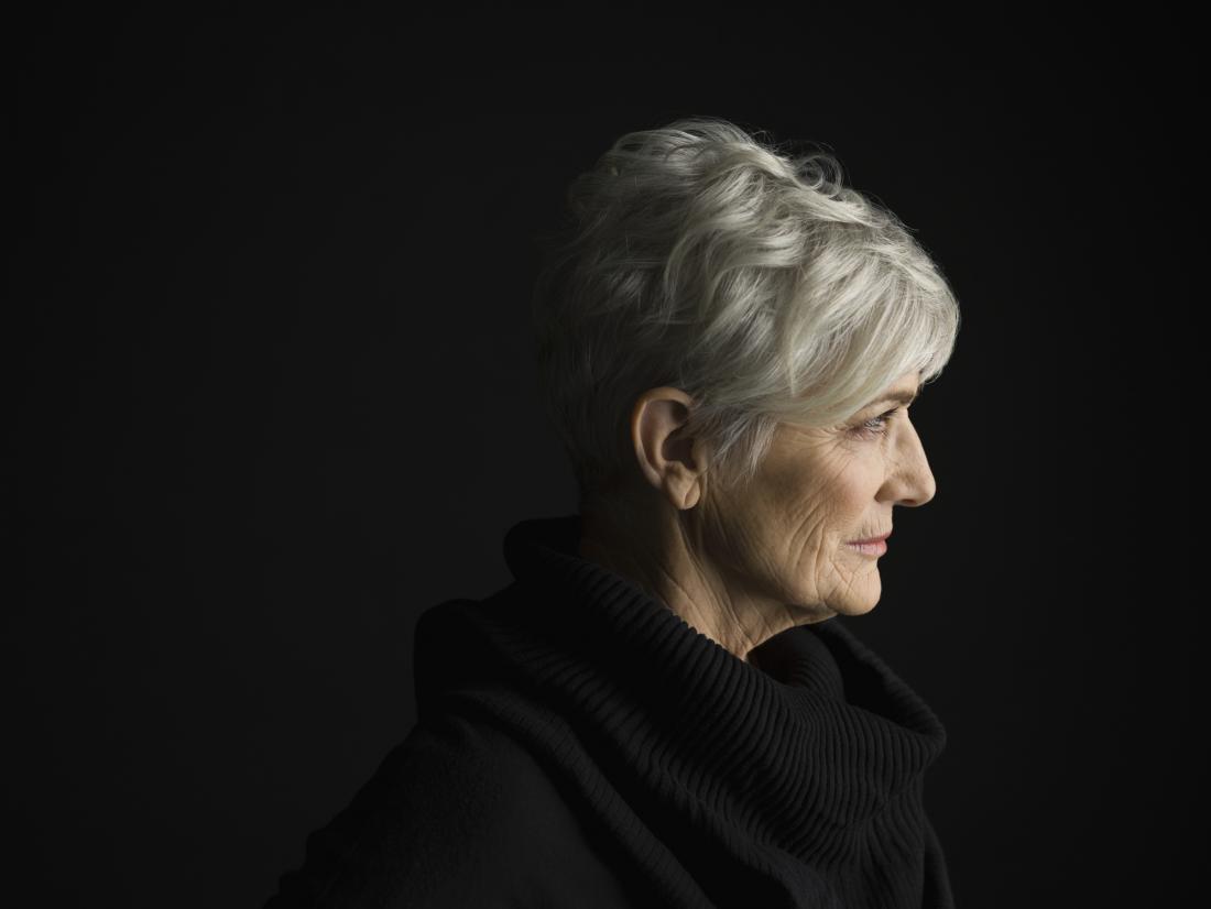 older woman with white hair and a black jumper