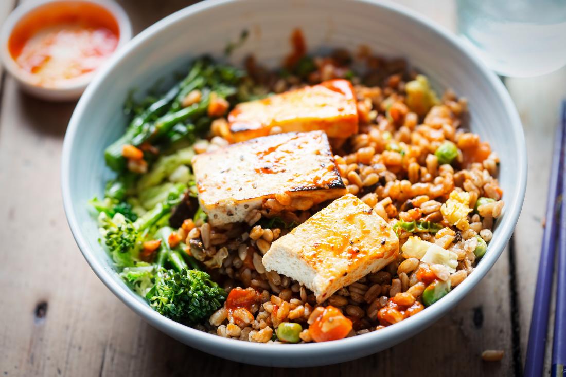 Spelt, broccoli, savoy cabbage with chargrilled tofu with sriracha as plant protein
