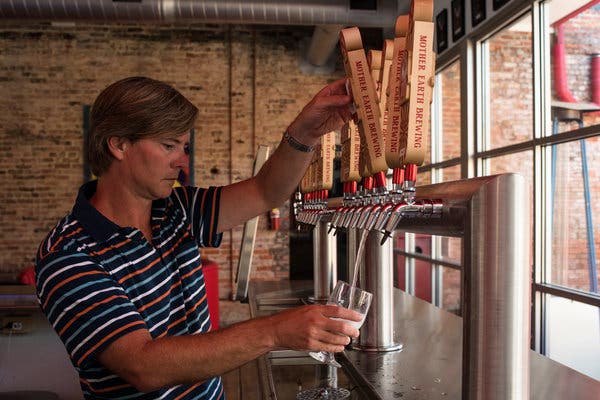 Trent Mooring, an owner of Mother Earth Brewing, pouring the mixed-berry flavor of Sercy at the brewery’s taproom in Kinston, N.C.