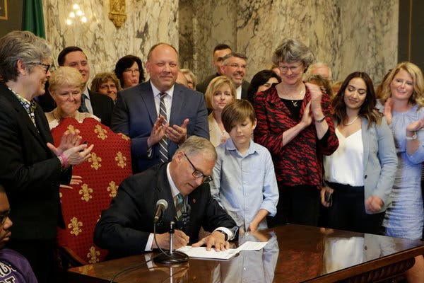 Jay Inslee, the governor of Washington, signing a measure in May that puts the state on track to create the nation’s first “public option” health insurance.