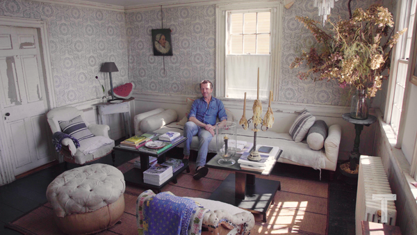 John Derian in “the blue room” of his Provincetown home, named for the mid-century wallpaper installed by his house’s previous owners.