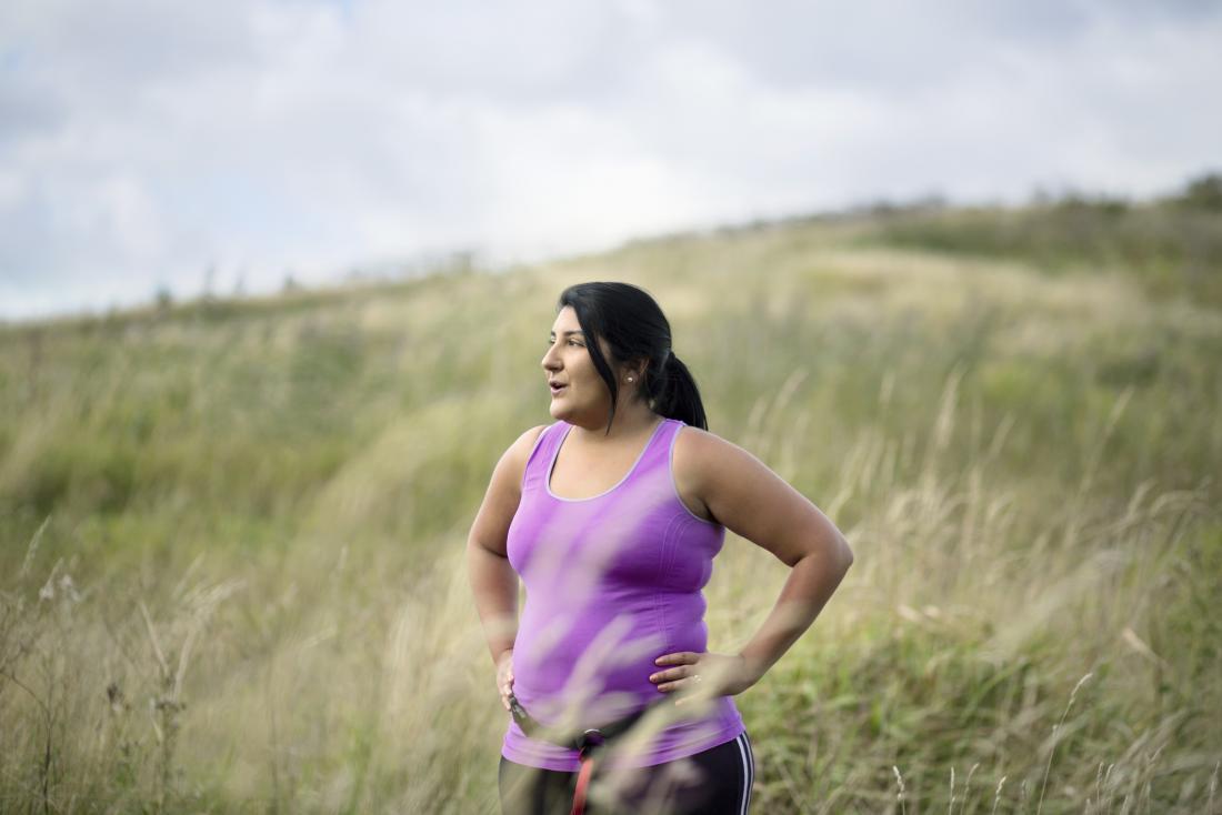 a woman pictured in a field after running