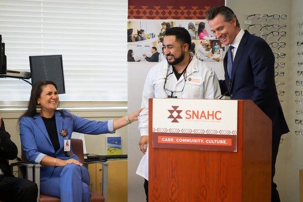 Gov. Gavin Newsom of California congratulated Dr. Byron Ruiz at the Sacramento Native American Health Center this month. Dr. Ruiz, a dentist, learned that morning he had been approved for the state’s loan repayment program.