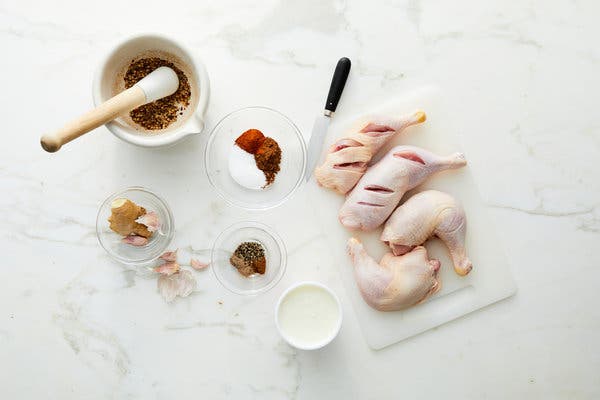 Ground spices are both rubbed onto the chicken skin and worked into a yogurt marinade.