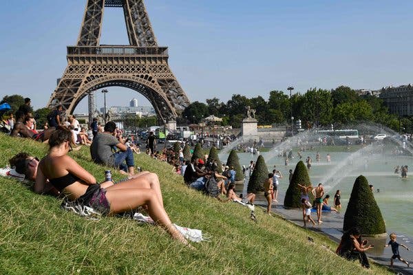 The Trocadero Fountains next to the Eiffel Tower in Paris have become a popular place to cool off. 