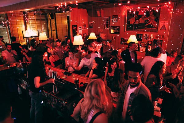 Patrons chat and have drinks at Ray's, a new bar located in the Lower East Side.
