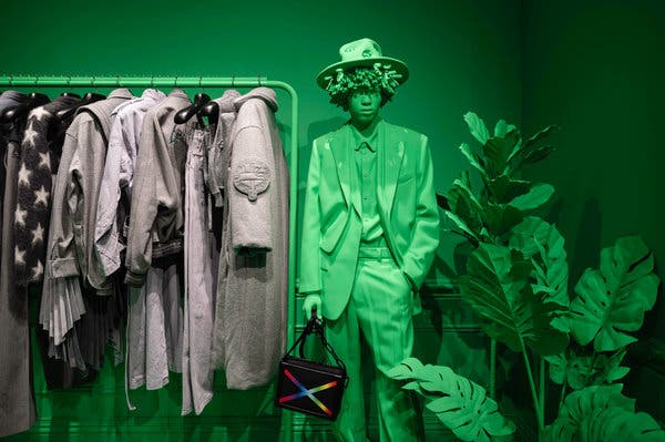 Life-size green figures, modeled after real models Virgil Abloh has worked with, dot the space.