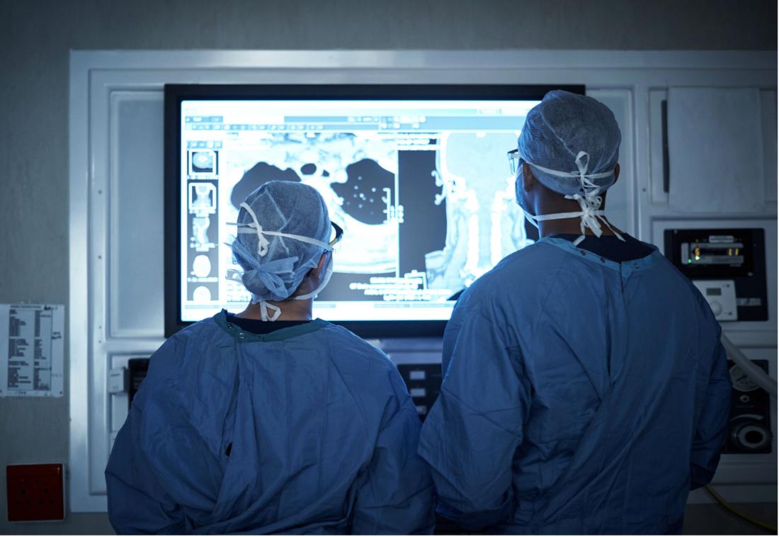 surgeons looking at a screen
