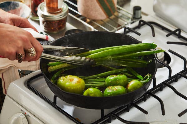 This recipe combines raw scallions or spring onions and tomatillos with their charred counterparts, seared in the same skillet in which the meat has cooked. 