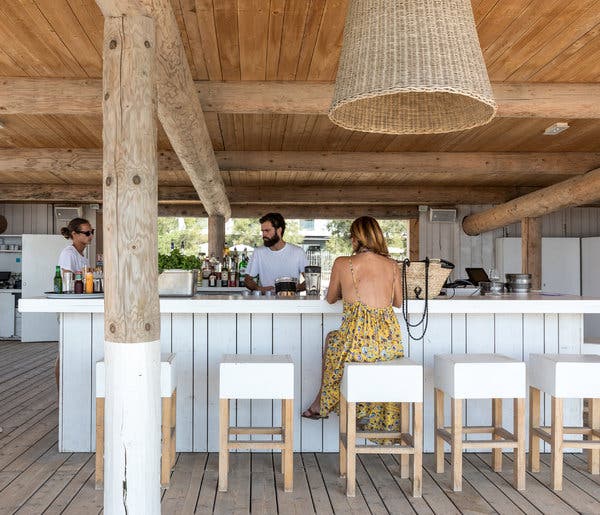 The decor at the Plage Palace runs to beach-shack white, including at the beach bar. 