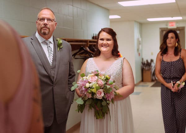 Ms. Marquardt prepares to walk down the aisle at the Open Door Christian Church, with her father, Steve Marquardt, in Spicer.