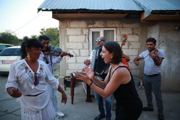 Mickela Mallozzi, right, meeting local musicians in the village of Clejani, Romania.