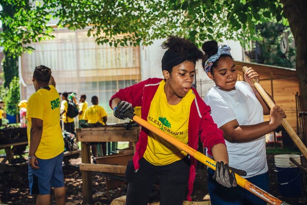 A counselor, Yesenia Leon, center, and Ta&rsquo;Cora Glenn, a camper, turning compost as they dance to the music of Michael Jackson and others at Harlem Grown&rsquo;s 127th Street farm.