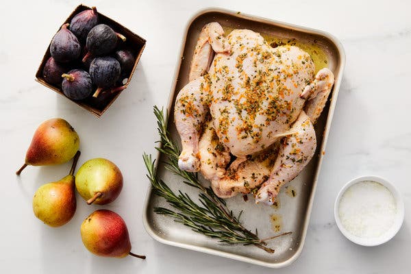 The chicken is rubbed with a marinade of garlic, orange zest, rosemary and salt and pepper.