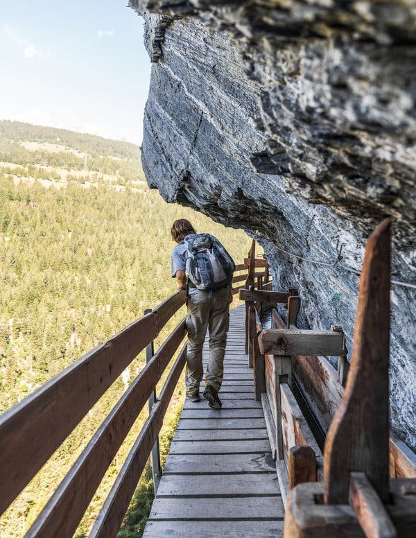 In some low-hanging sections, hikers have to duck to avoid rock faces.