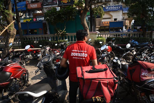A Zomato delivery agent collecting a delivery order at a restaurant in the Galleria Market in Gurugram, a New Delhi suburb home to many tech companies, including Zomato.