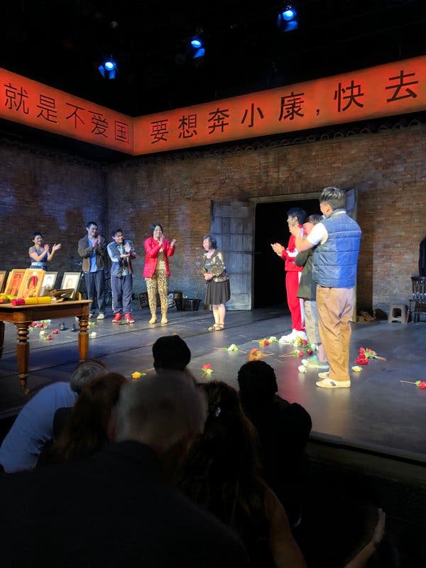 Dr. Wang, center, at the Hampstead Theater in London at the opening of “The King of Hell’s Palace,” a play based on her experiences.