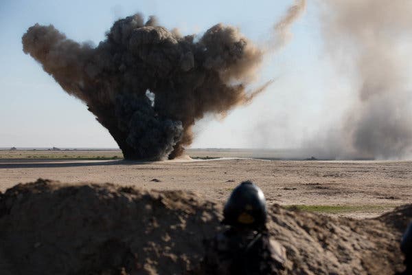 A student watches an explosive ordnance disposal demonstration during training at the Besmaya Range Complex, Iraq, in December 2018.