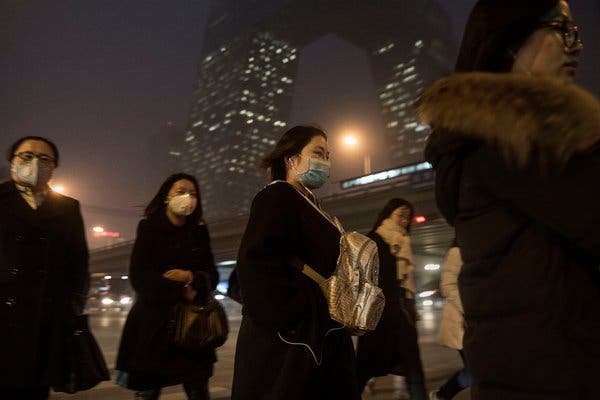 Chinese women wearing masks to protect against pollution in Beijing in 2015. The government has made inroads against China’s pollution problem. 