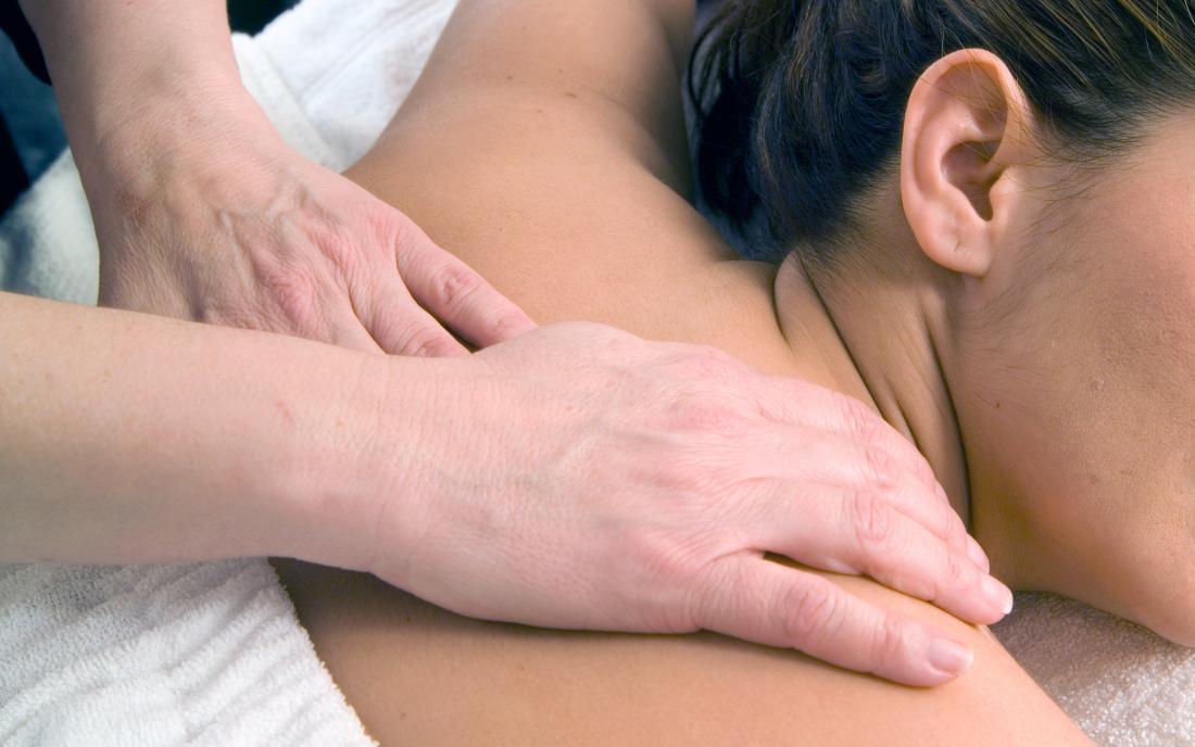 a woman receiving either a swedish massage or deep tissue
